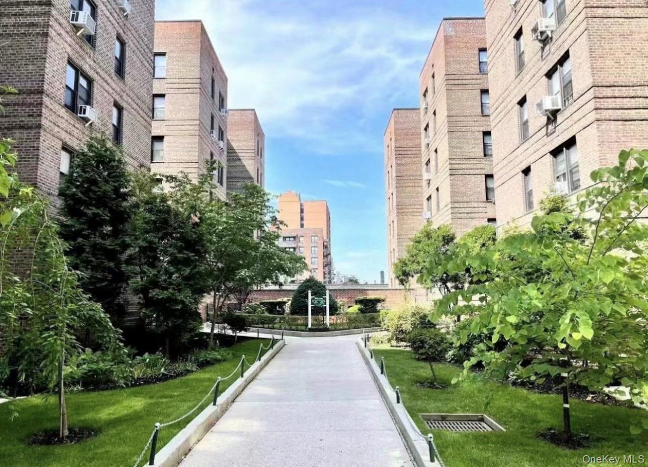 43-40 Union Street, Unit 2D Queens, NY 11355 - Photo 1 of 5 a front view of a multi story building with yard
