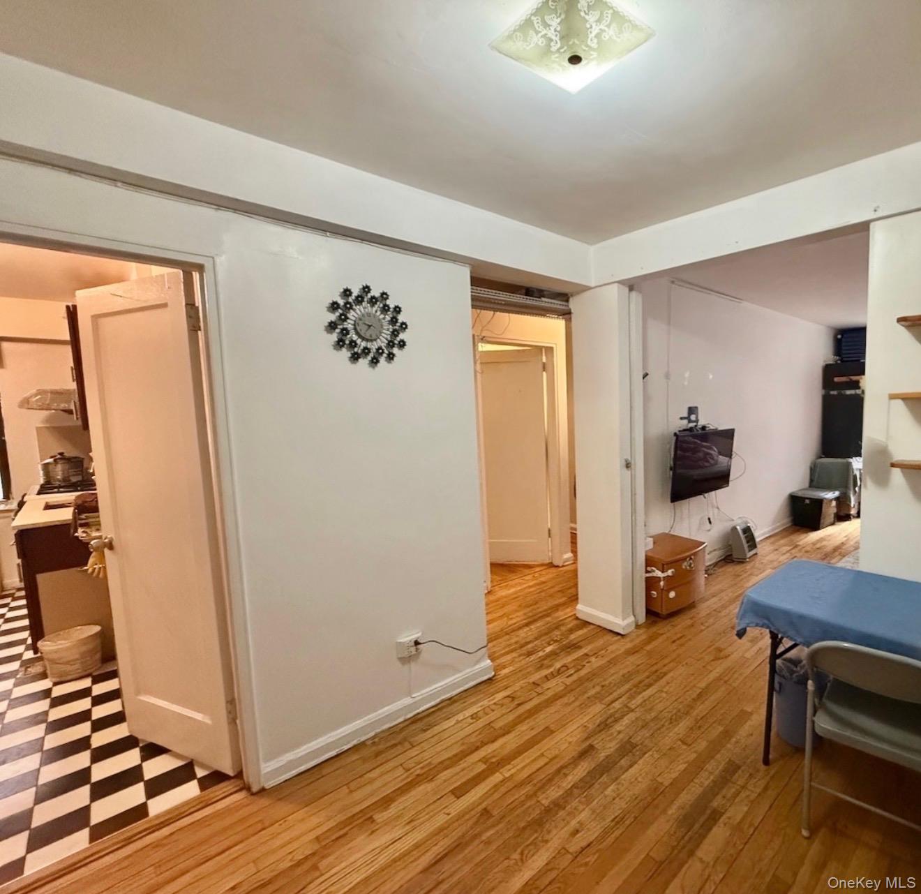 43-40 Union Street, Unit 2D Queens, NY 11355 - Photo 3 of 5 a view of a bedroom with wooden floor and furniture