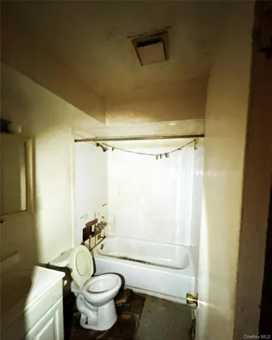 a bathroom with a granite countertop toilet a sink and a shower