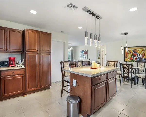 a kitchen with a stove a refrigerator and a dining table
