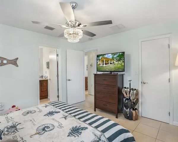 a bedroom with a bed and a chandelier