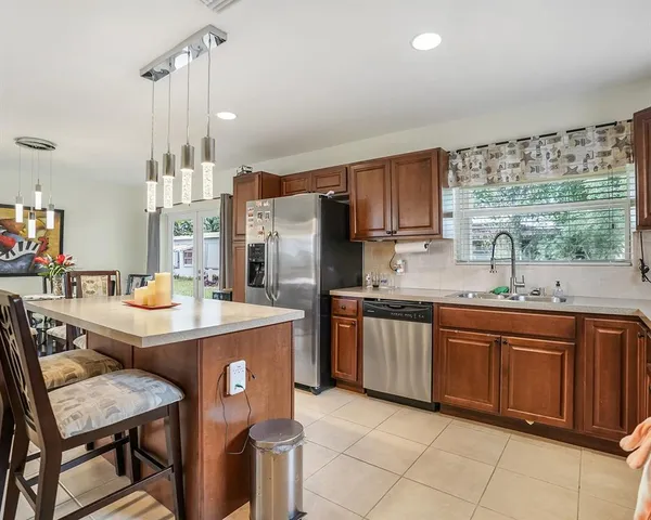 a kitchen with sink cabinets and wooden floor