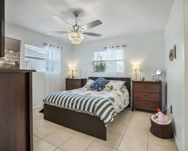 a bedroom with a bed and ceiling fan