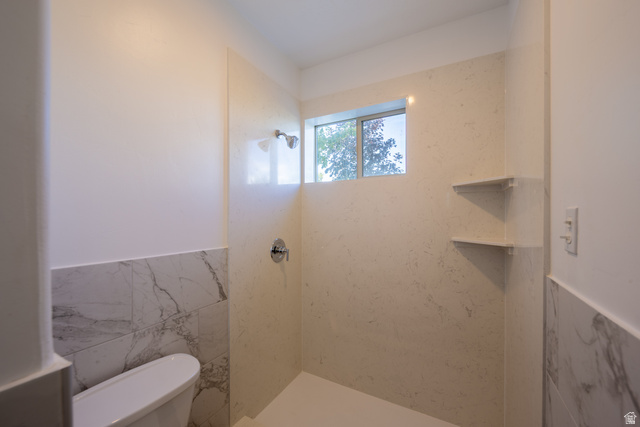 868 Braddock Lane Alpine, UT 84004 - Photo 50 of 64 Walk-in shower featuring a chrome showerhead, a recessed window, and two corner storage shelves