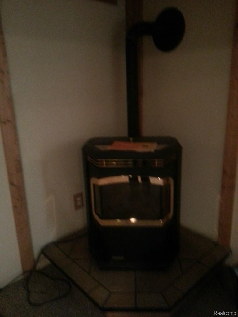 7191 Mentel Road Newport, MI 48166 - Photo 32 of 33 Mentel Basement Pellet Stove
