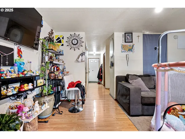 a living room filled with furniture and a flat screen tv