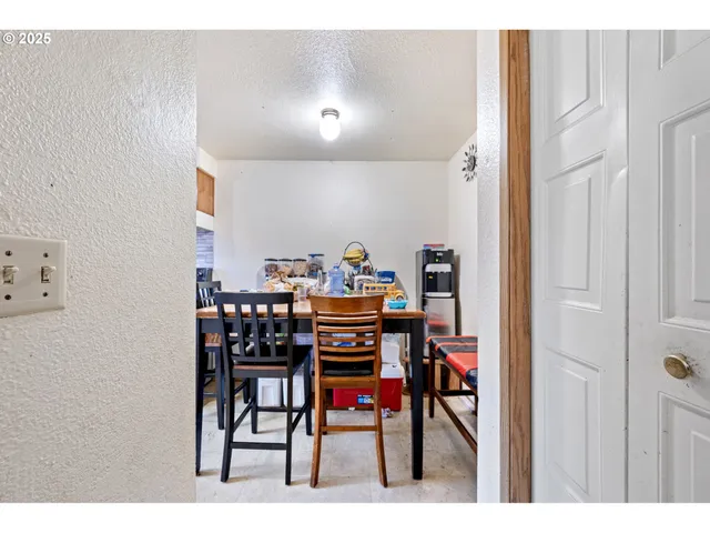 a view of a dining room with furniture and a rug