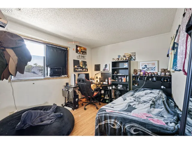 a bed room with a bed and a chair