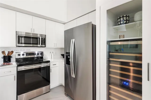 a kitchen with stainless steel appliances and refrigerator