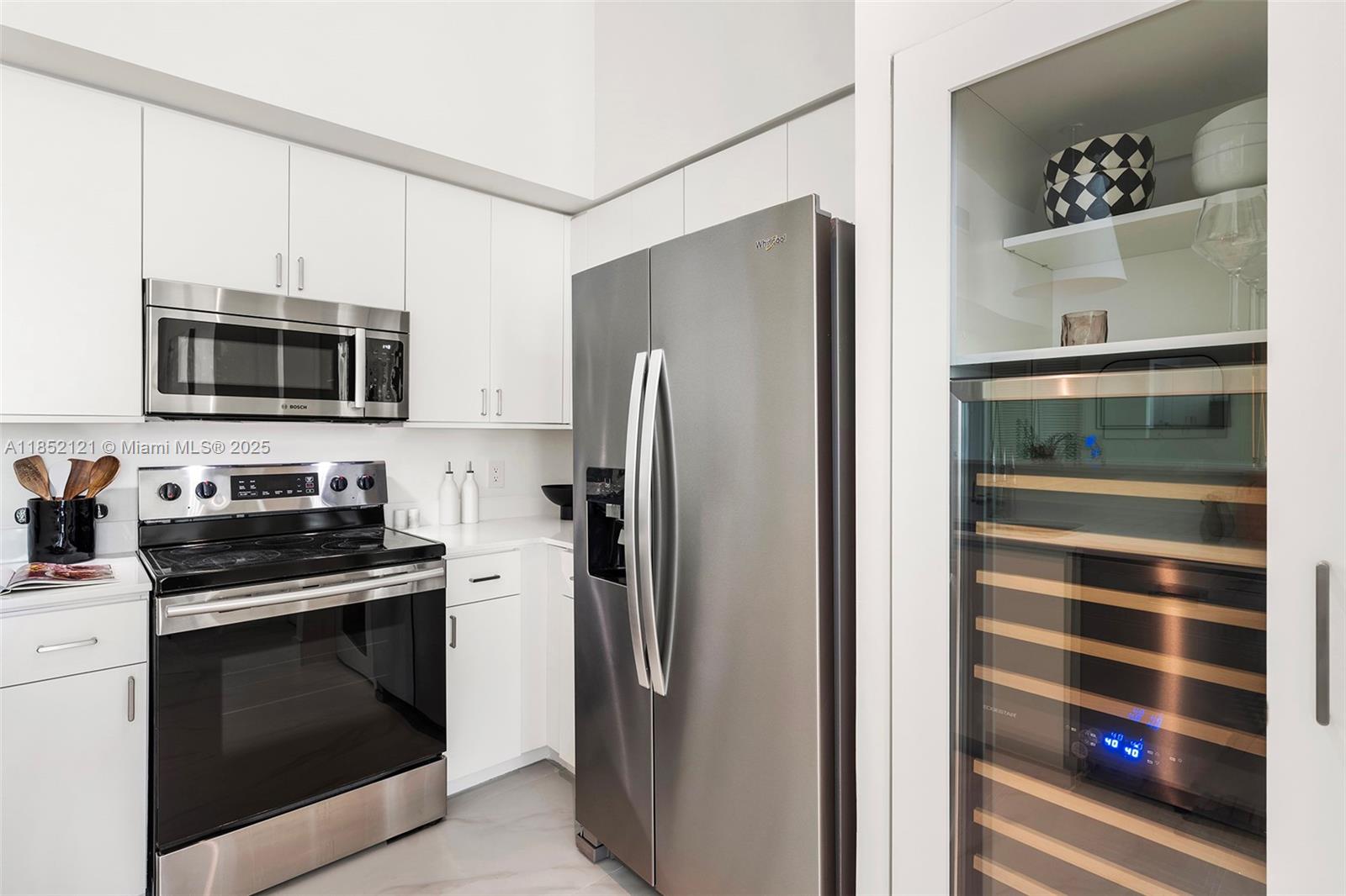 1155 Brickell Bay Drive, Unit 203 Miami, FL 33131 - Photo 11 of 36 a kitchen with stainless steel appliances and refrigerator