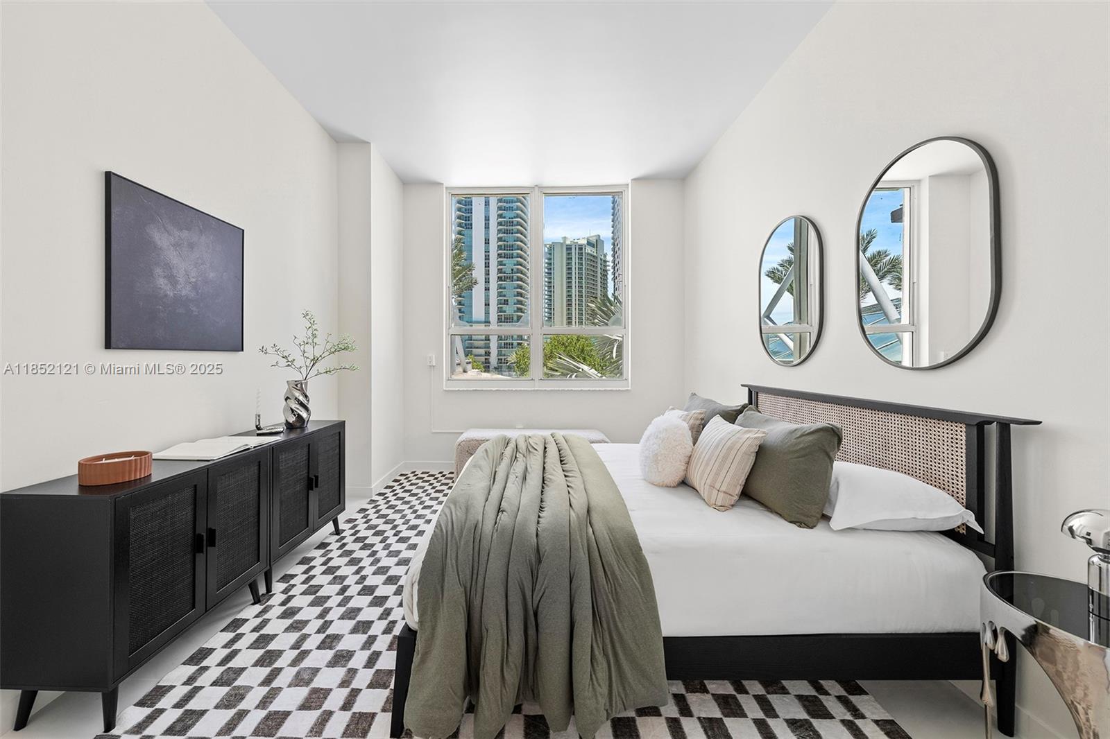 1155 Brickell Bay Drive, Unit 203 Miami, FL 33131 - Photo 12 of 36 a bedroom with a bed and wooden floor