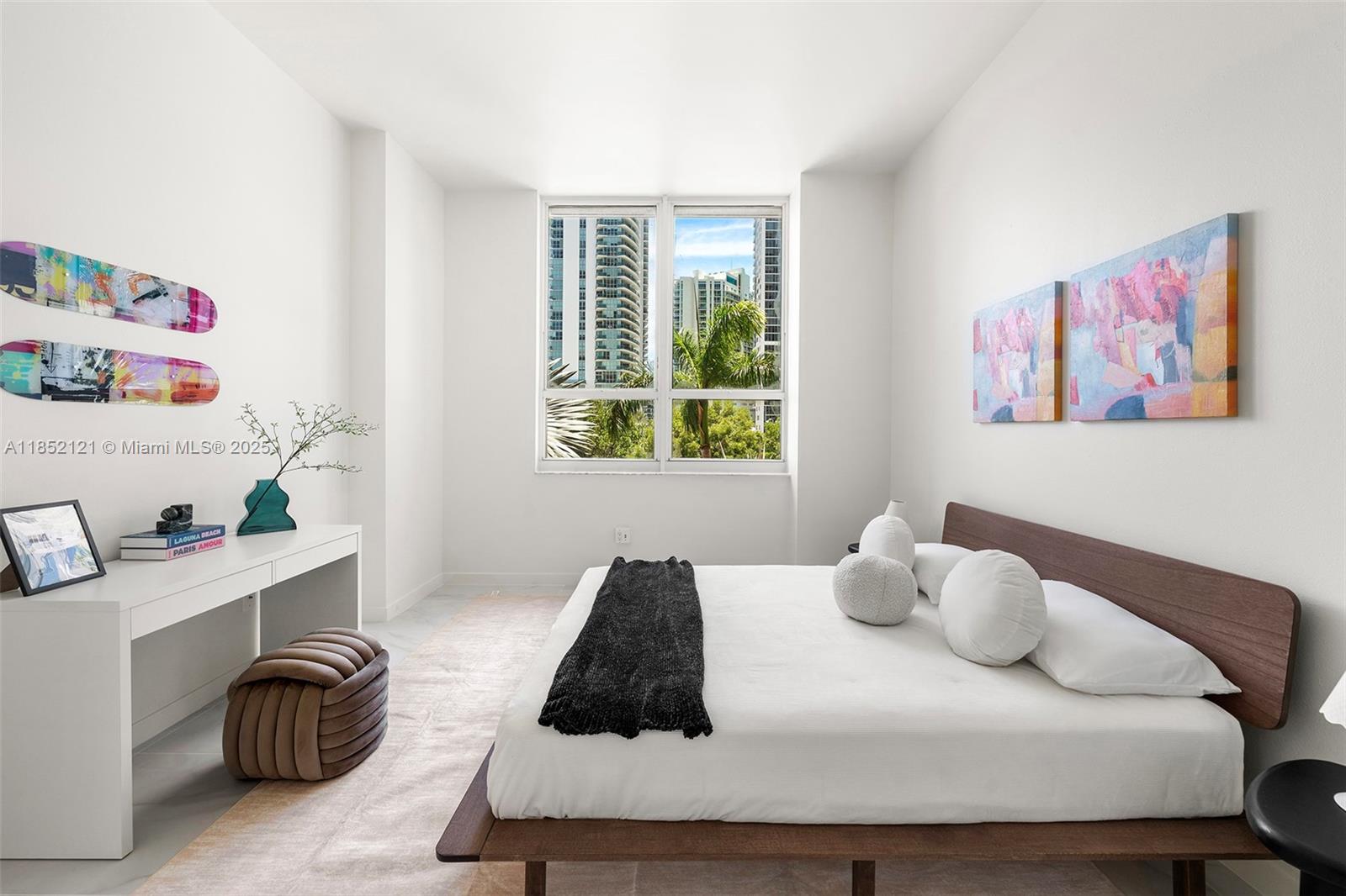 1155 Brickell Bay Drive, Unit 203 Miami, FL 33131 - Photo 15 of 36 a bedroom with a bed and a window