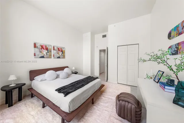 a bedroom with furniture and a potted plant