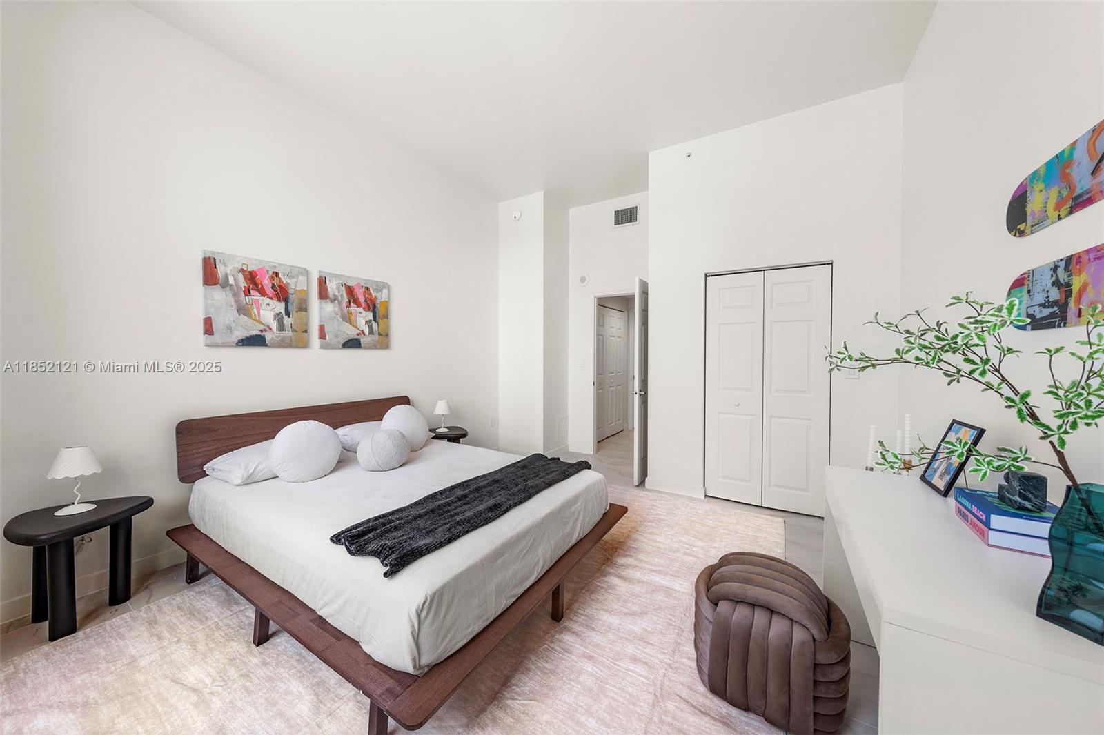 1155 Brickell Bay Drive, Unit 203 Miami, FL 33131 - Photo 16 of 36 a bedroom with furniture and a potted plant