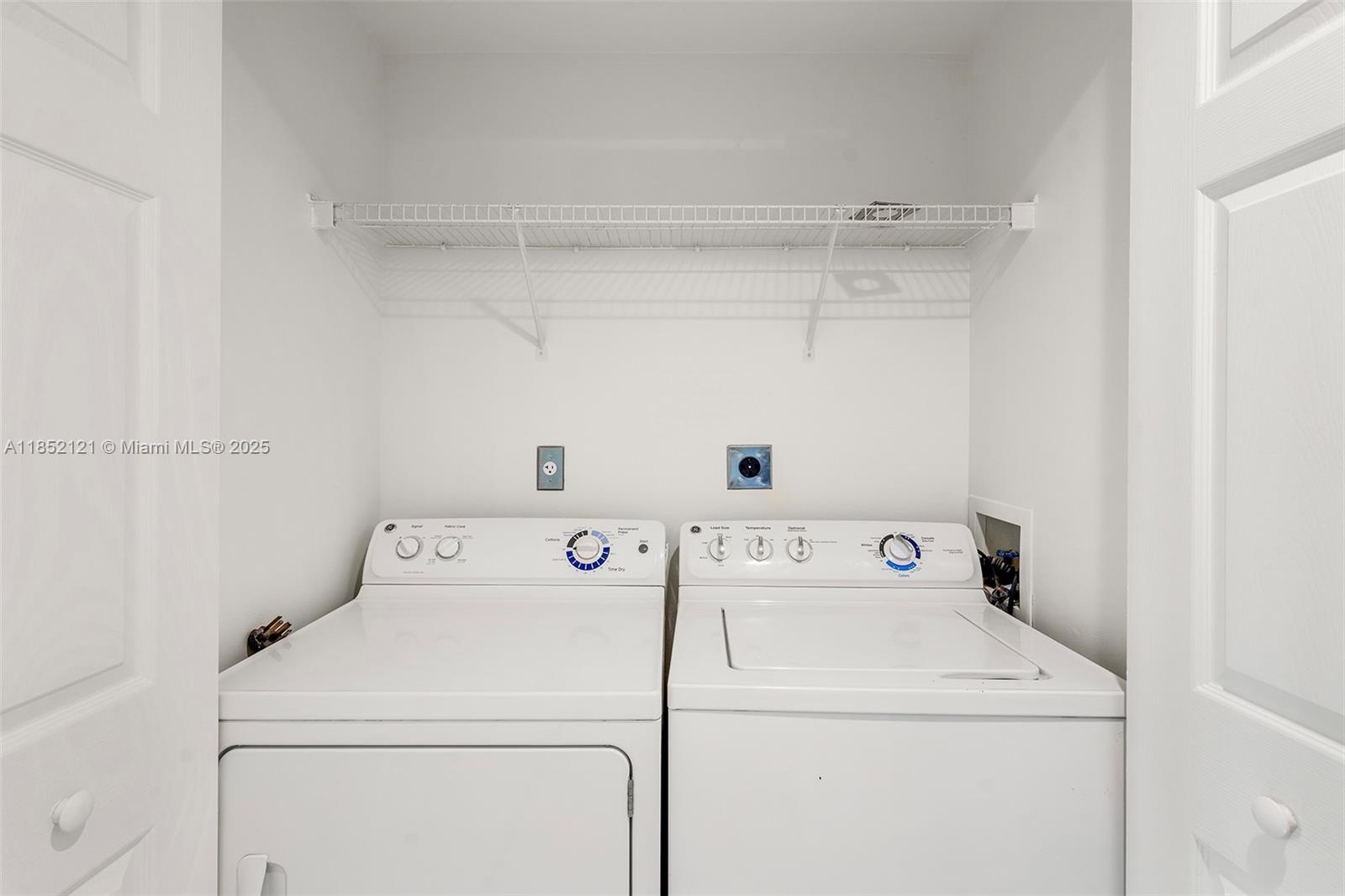1155 Brickell Bay Drive, Unit 203 Miami, FL 33131 - Photo 19 of 36 a utility room with dryer and washer