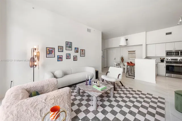 a living room with furniture and kitchen view