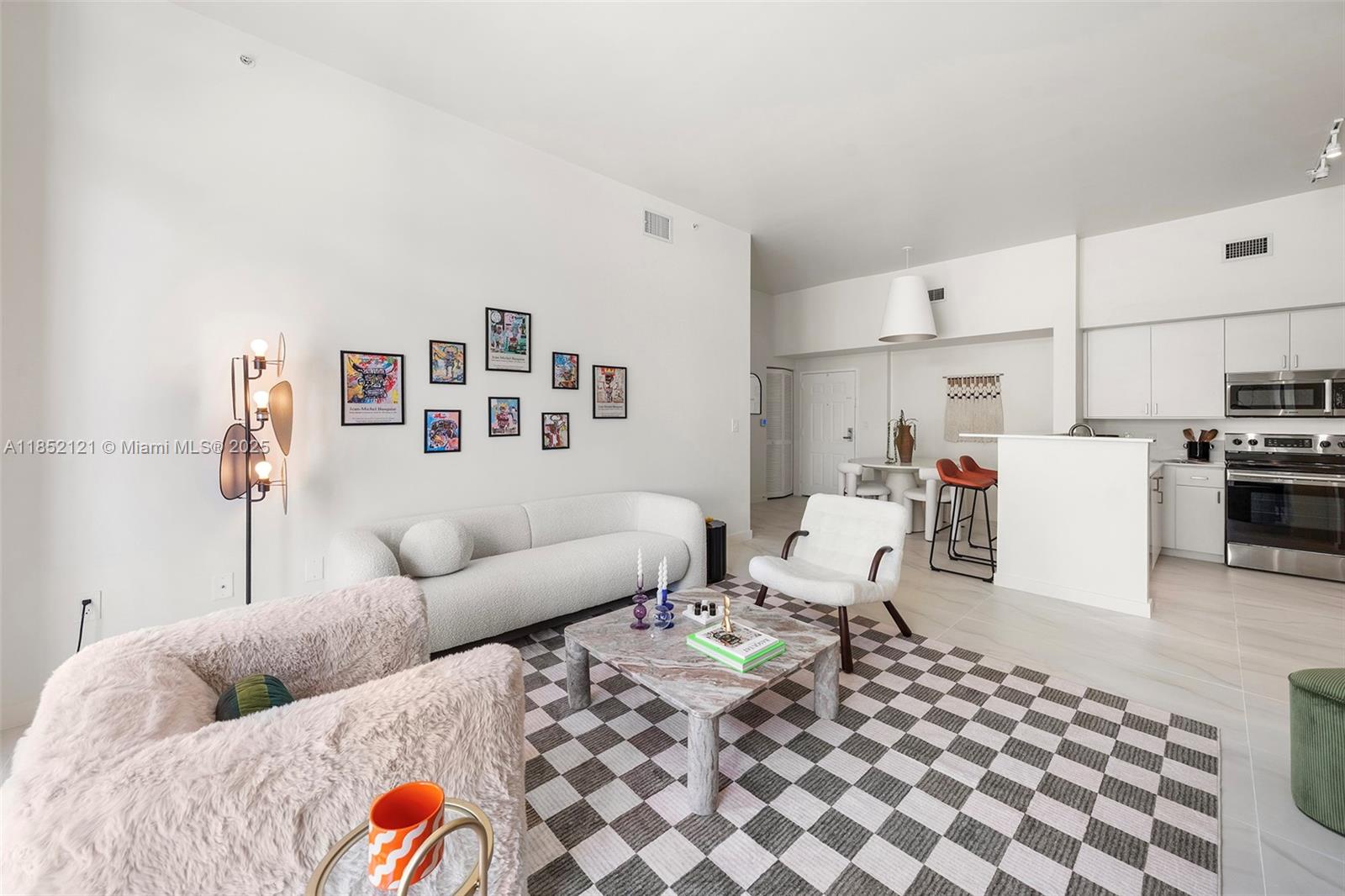 1155 Brickell Bay Drive, Unit 203 Miami, FL 33131 - Photo 20 of 36 a living room with furniture and kitchen view