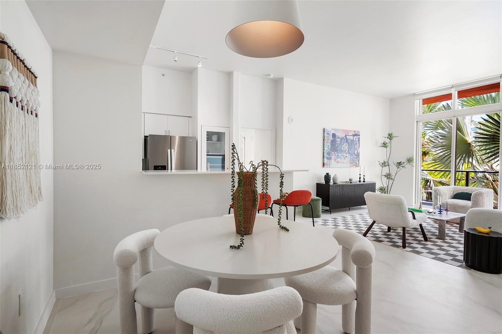 1155 Brickell Bay Drive, Unit 203 Miami, FL 33131 - Photo 3 of 36 a view of a dining room with furniture and wooden floor