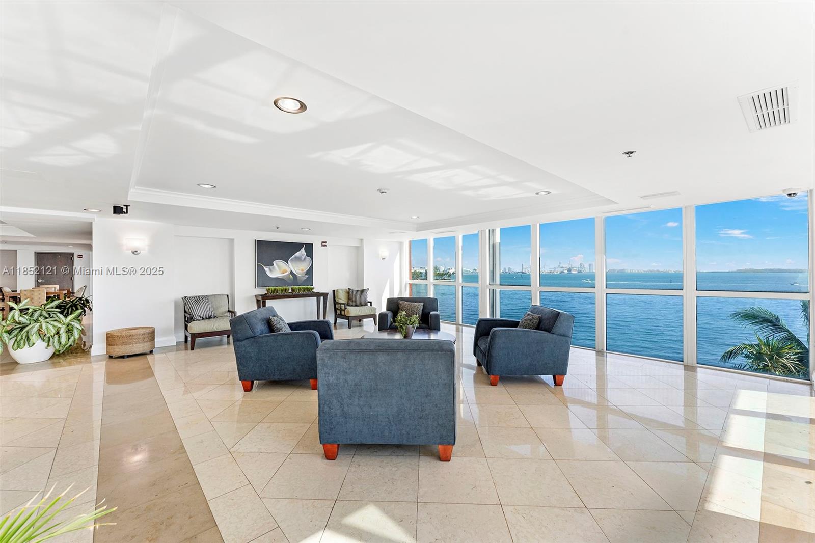 1155 Brickell Bay Drive, Unit 203 Miami, FL 33131 - Photo 31 of 36 a living room with furniture potted plant and a large window