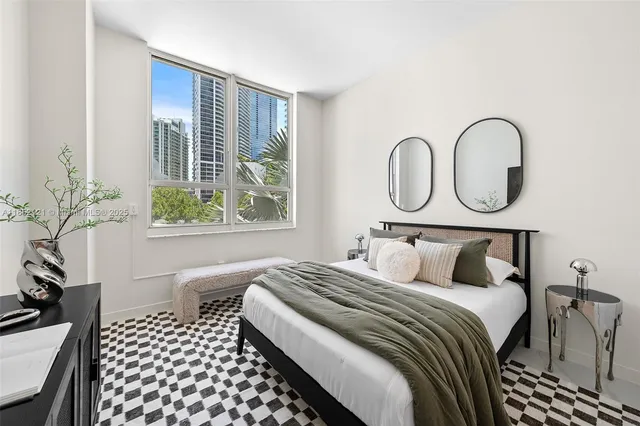 a bedroom with bed and a window