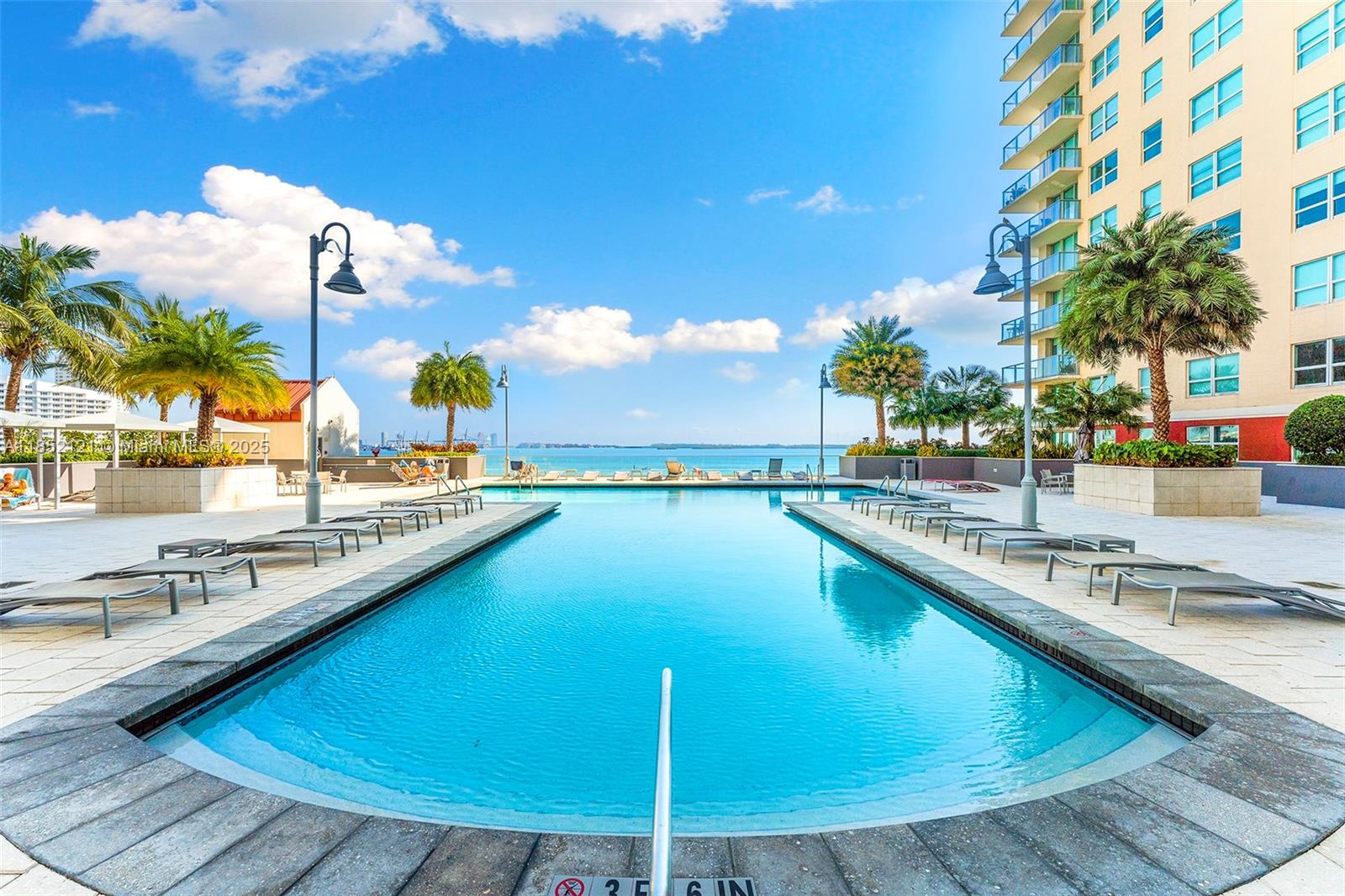 1155 Brickell Bay Drive, Unit 203 Miami, FL 33131 - Photo 7 of 36 a view of a swimming pool with a lounge chairs
