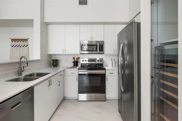 a kitchen with a sink and a refrigerator