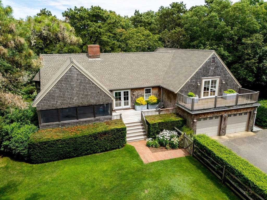 a aerial view of a house with swimming pool next to a big yard
