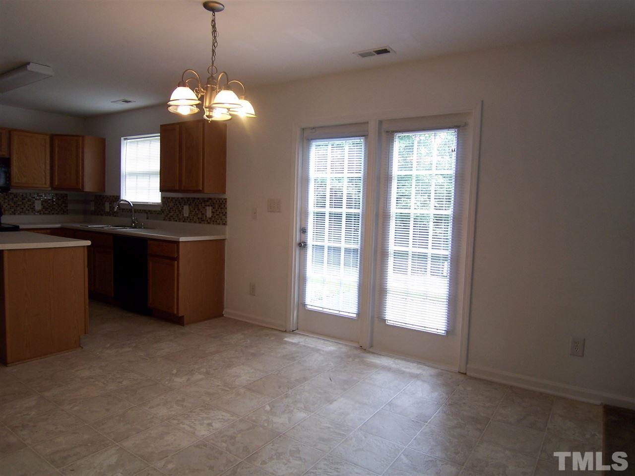 3904 Tyler Bluff Lane Raleigh, NC 27616 - Photo 5 of 13 a view of a kitchen with granite countertop stainless steel appliances and a chandelier