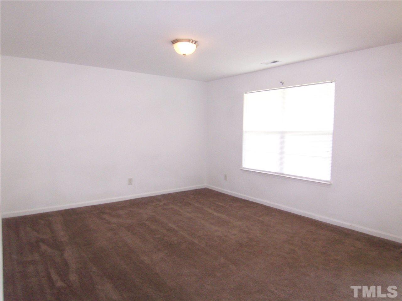 3904 Tyler Bluff Lane Raleigh, NC 27616 - Photo 6 of 13 an empty room with a window