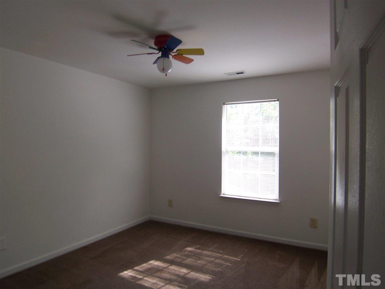 3904 Tyler Bluff Lane Raleigh, NC 27616 - Photo 9 of 13 an empty room with a window