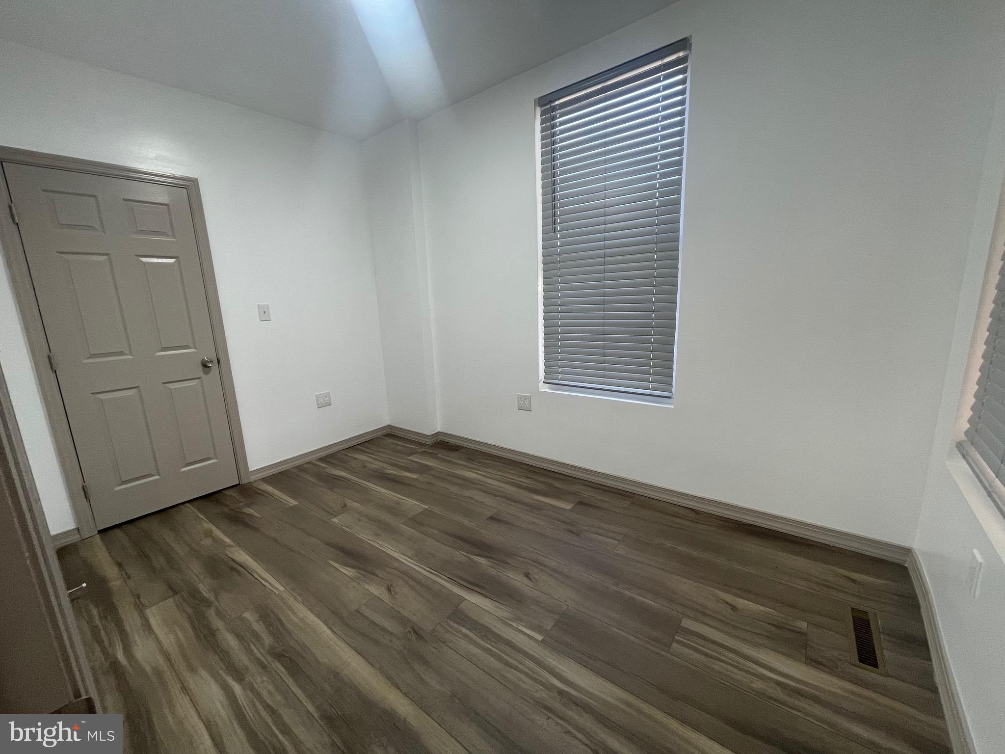 20 Pennsylvania Avenue, Unit 1 Reading, PA 19605 - Photo 13 of 17 an empty room with wooden floor and windows