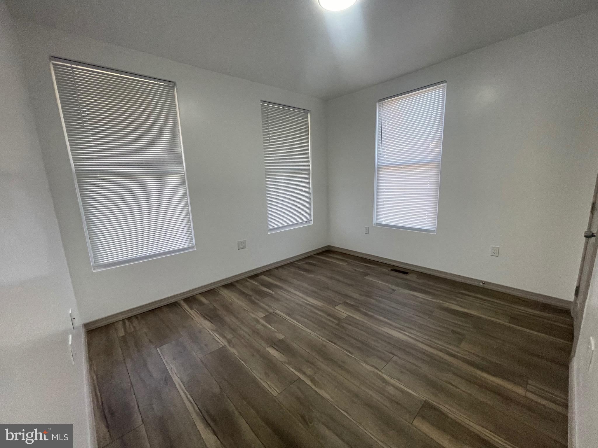 20 Pennsylvania Avenue, Unit 1 Reading, PA 19605 - Photo 16 of 17 an empty room with wooden floor and windows