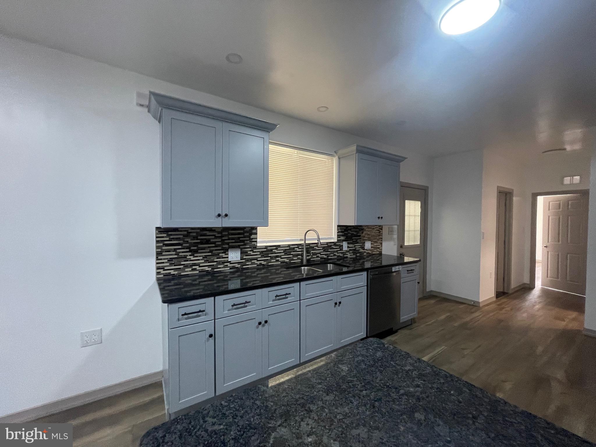 20 Pennsylvania Avenue, Unit 1 Reading, PA 19605 - Photo 5 of 17 a large bathroom with a granite countertop sink and a mirror