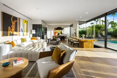 a living room with furniture floor to ceiling window and floor to ceiling window