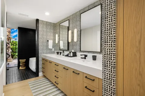 a spacious bathroom with a double vanity sink and a mirror