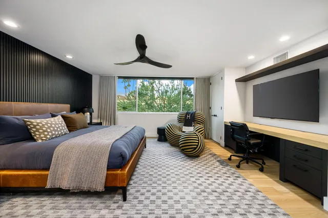 a bathroom with a sink a mirror and potted plants