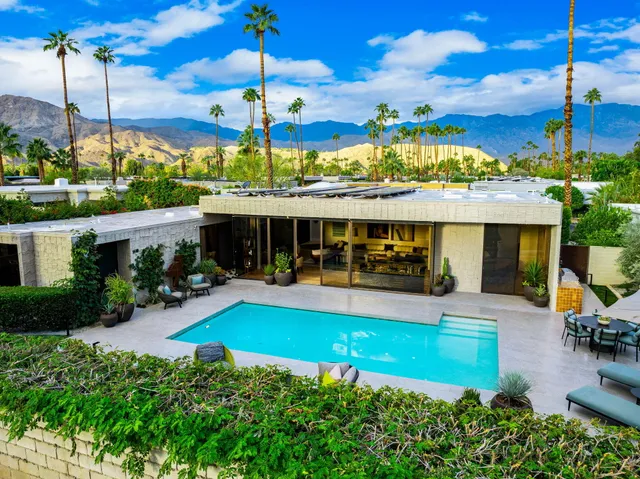 a view of a house with swimming pool patio and outdoor seating