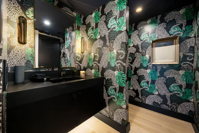 a room with pool table and chairs