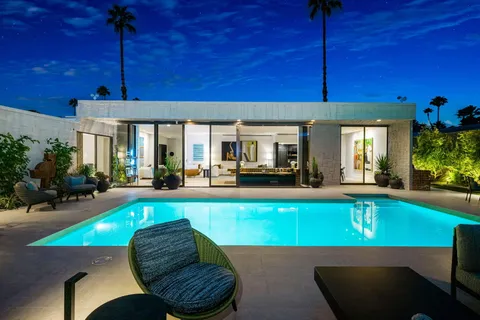 a view of swimming pool with outdoor seating