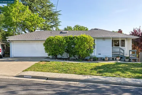 a view of a house with a yard and plants