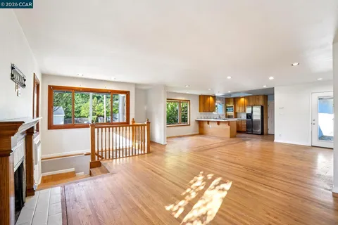 a view of a room with wooden floor and windows