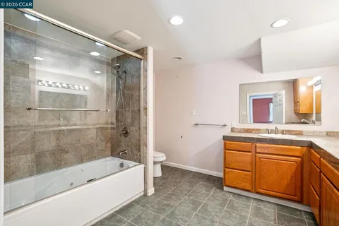 a view of house with backyard and wooden fence