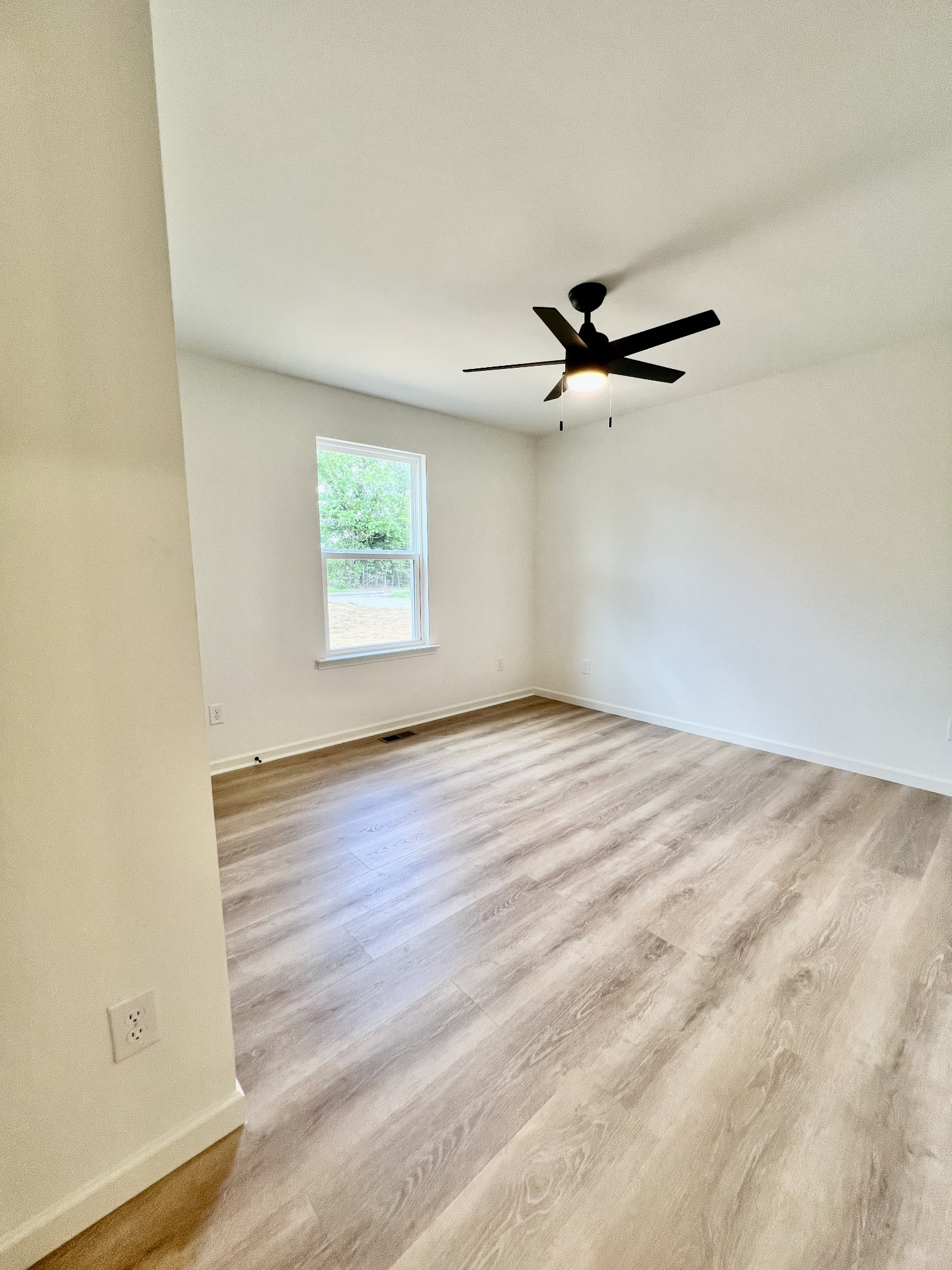 5712 Little Dry Creek Road Pulaski, TN 38478 - Photo 25 of 34 wooden floor in an empty room with a window