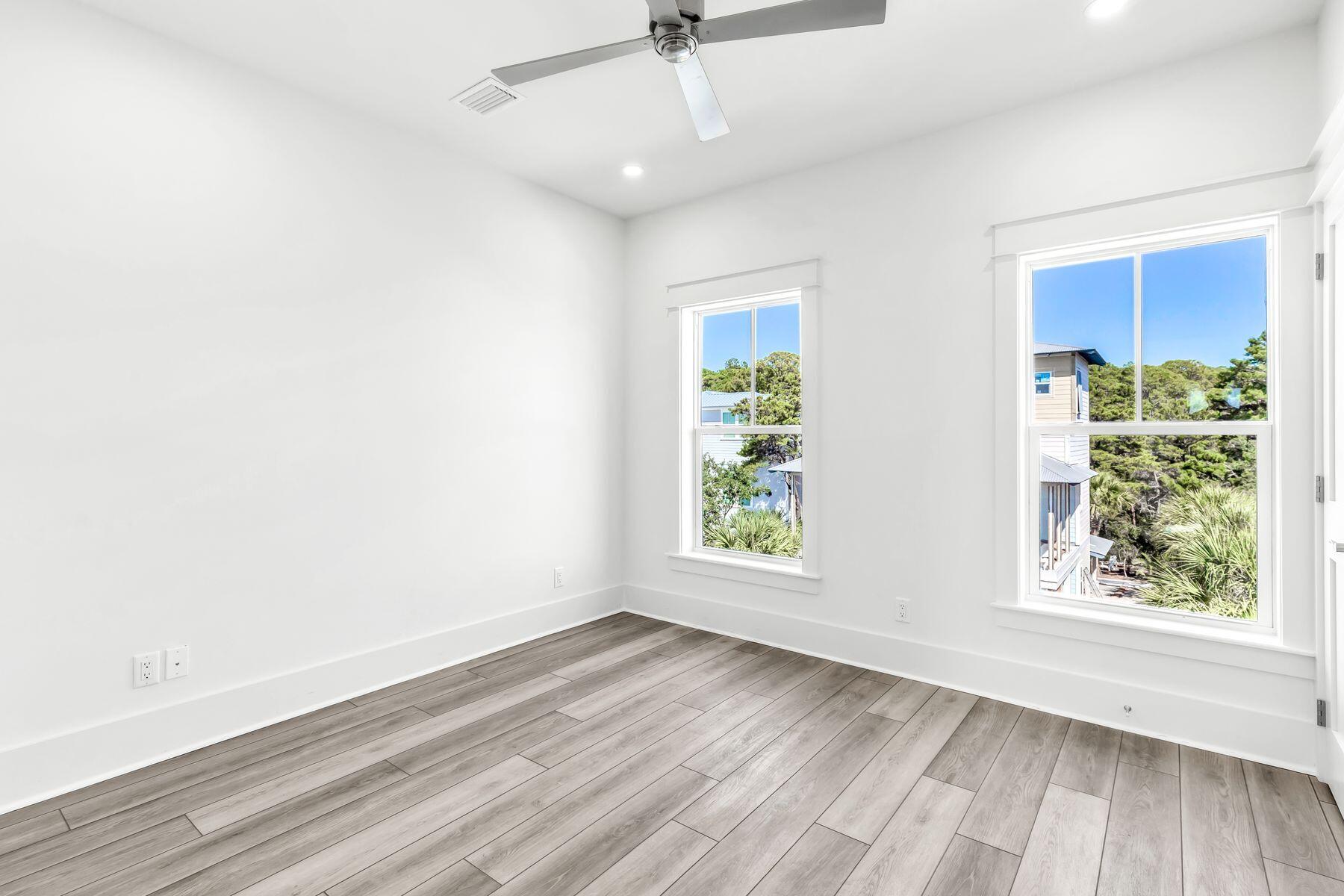 163 Beach Bike Way Inlet Beach Inlet Beach, FL 32461 - Photo 11 of 32 an empty room with wooden floor windows and outdoor view