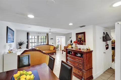 a view of a dining room with furniture a rug and wooden floor