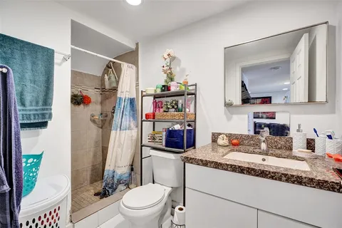 a bedroom with a large bed and a mirror