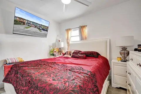 a bedroom that has two beds and a large mirror in it