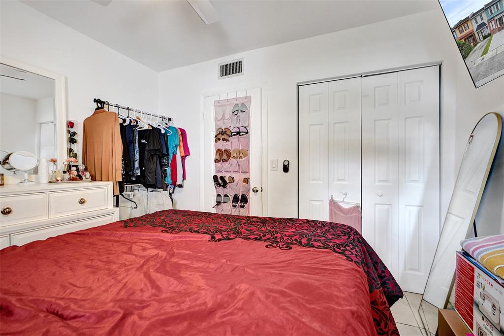 1732 West 72nd Street, Unit 1732 Hialeah, FL 33014 - Photo 23 of 58 a bedroom with a large bed and a mirror