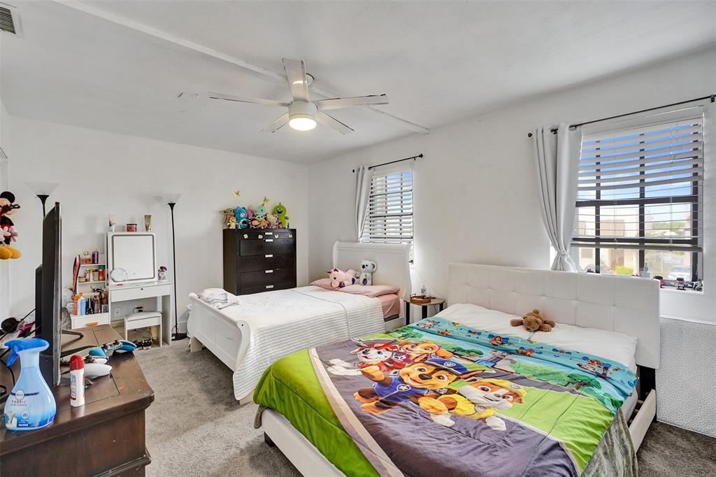 1732 West 72nd Street, Unit 1732 Hialeah, FL 33014 - Photo 25 of 58 a bedroom that has two beds and a large mirror in it