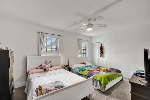a bathroom with a granite countertop sink mirror vanity and toilet